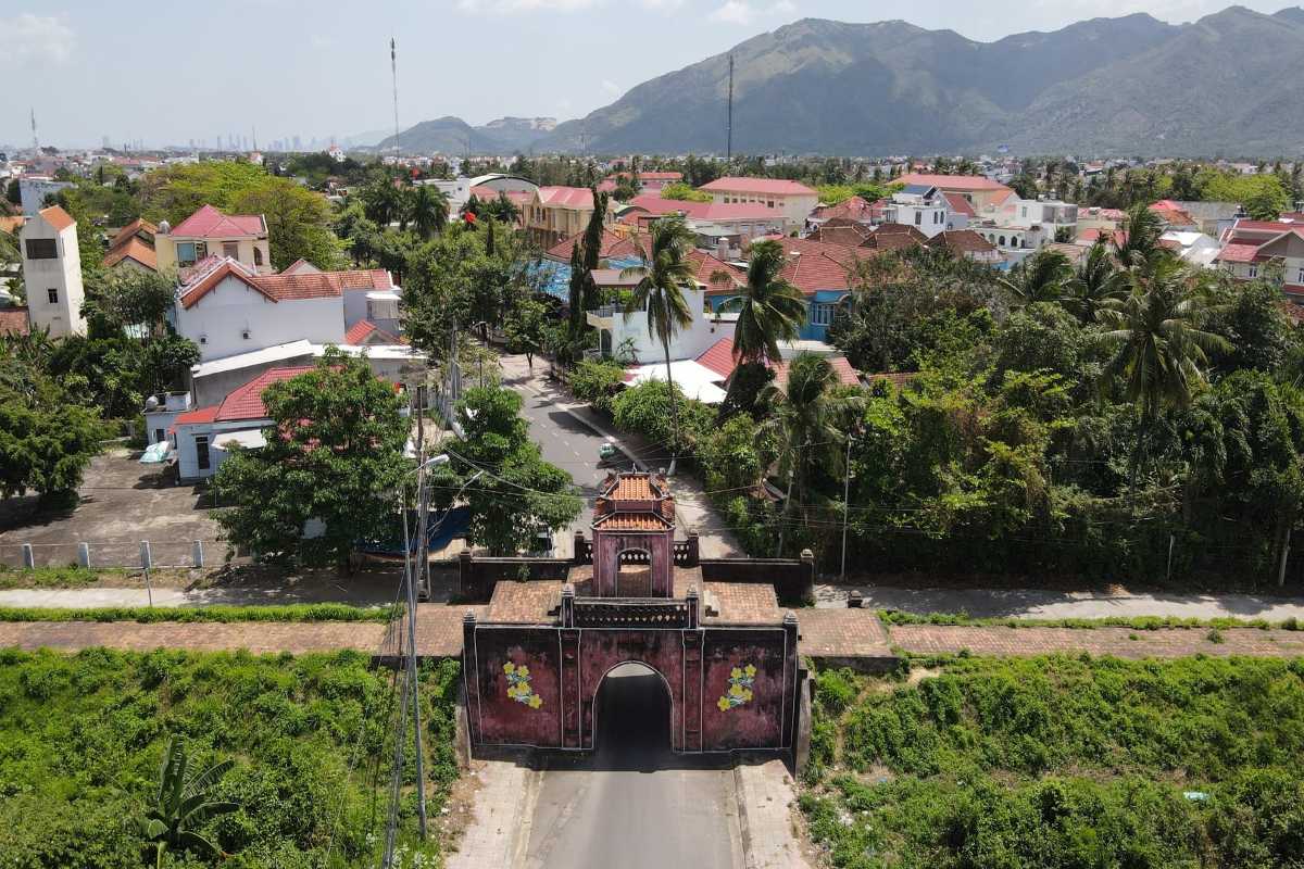 Front View of Diên Khánh Citadel Gate Frontal view of the iconic Diên Khánh Citadel gate surrounded by tropical greenery.