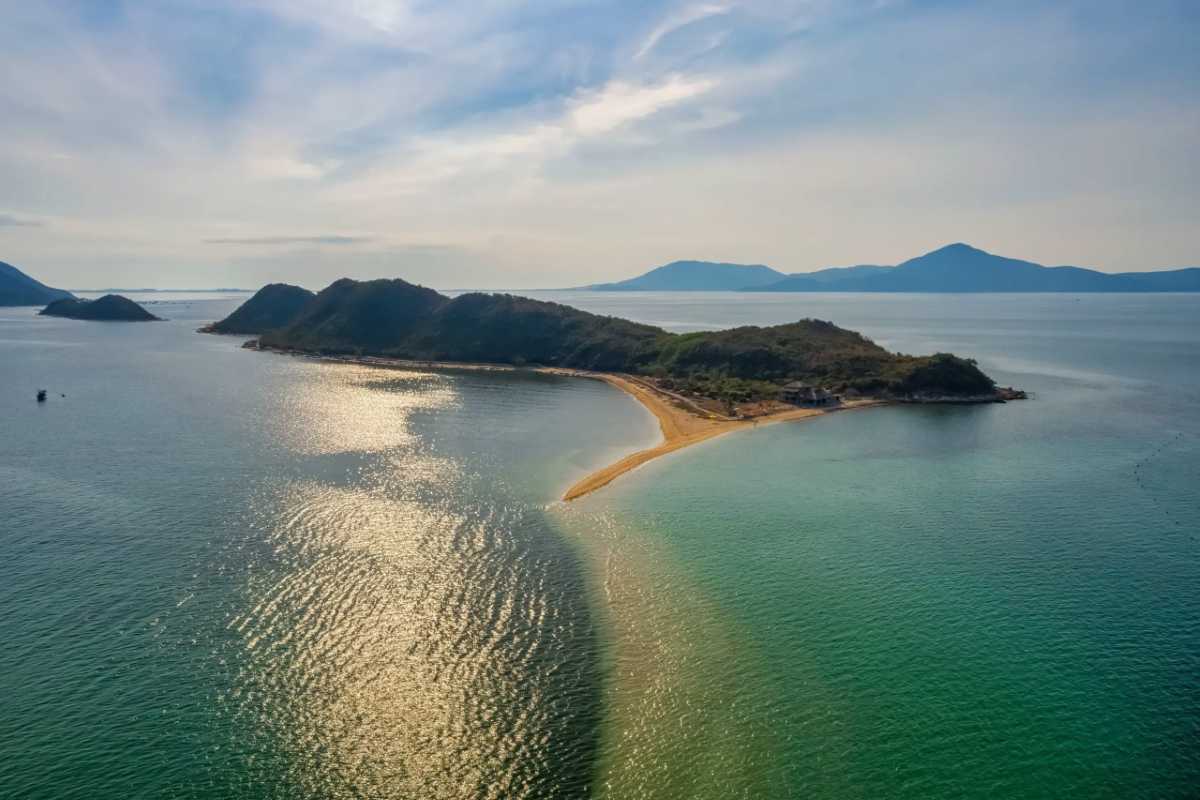 Aerial View of Diep Son Island and Sandbar in Nha Trang Aerial view showing the long sandbar and lush green island of Diep Son Island near Nha Trang