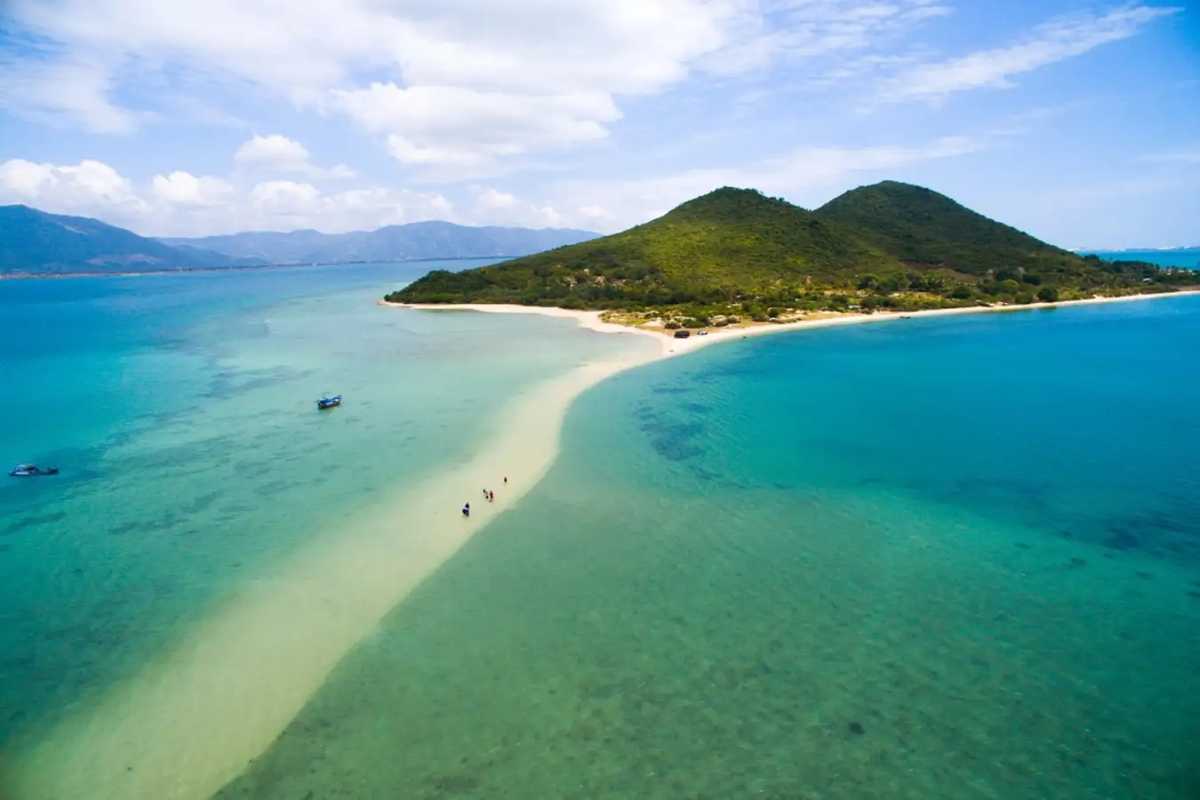 Sandbar and Boat at Diep Son Island in Nha Trang Boat anchored beside the sandbar at Diep Son Island with clear blue water and sandy shore