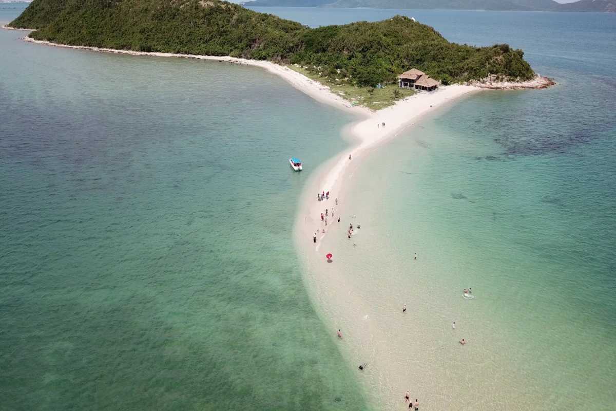 Tourists Exploring Diep Son Island Sandbar from Above Tourists walking along the Diep Son Island sandbar surrounded by clear shallow waters