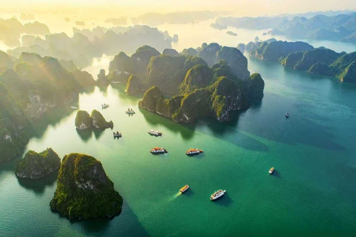 Dinh Huong Islet Halong Bay rocky islet cluster Cluster of rocky islets in Dinh Huong Islet Halong Bay with lush greenery and calm waters