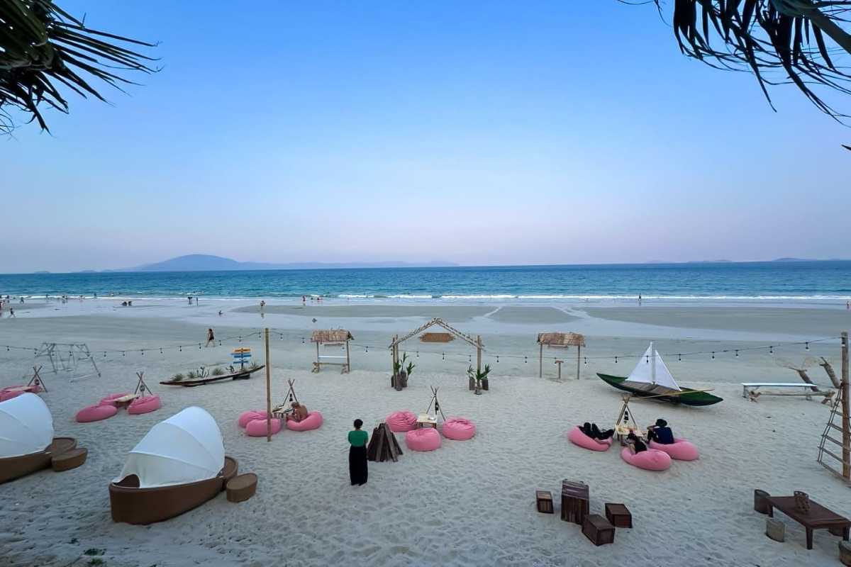 Beach Setup at Sunset on Doc Let Beach Cozy beanbags and beach swings set up along the white sands of Doc Let Beach with evening blue skies and sea horizon.