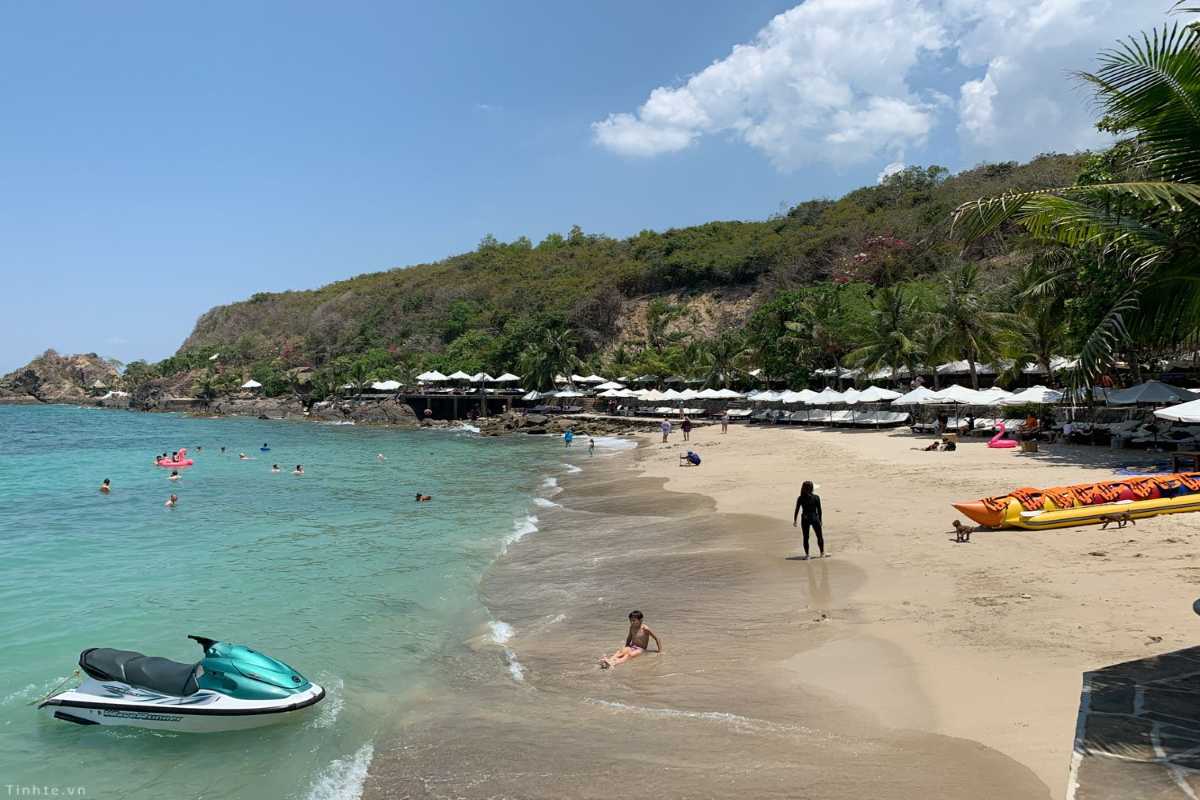 Water Sports at Doc Let Beach Cove People enjoying water sports and jet skis along the rocky cove edge of Doc Let Beach beneath bright skies.