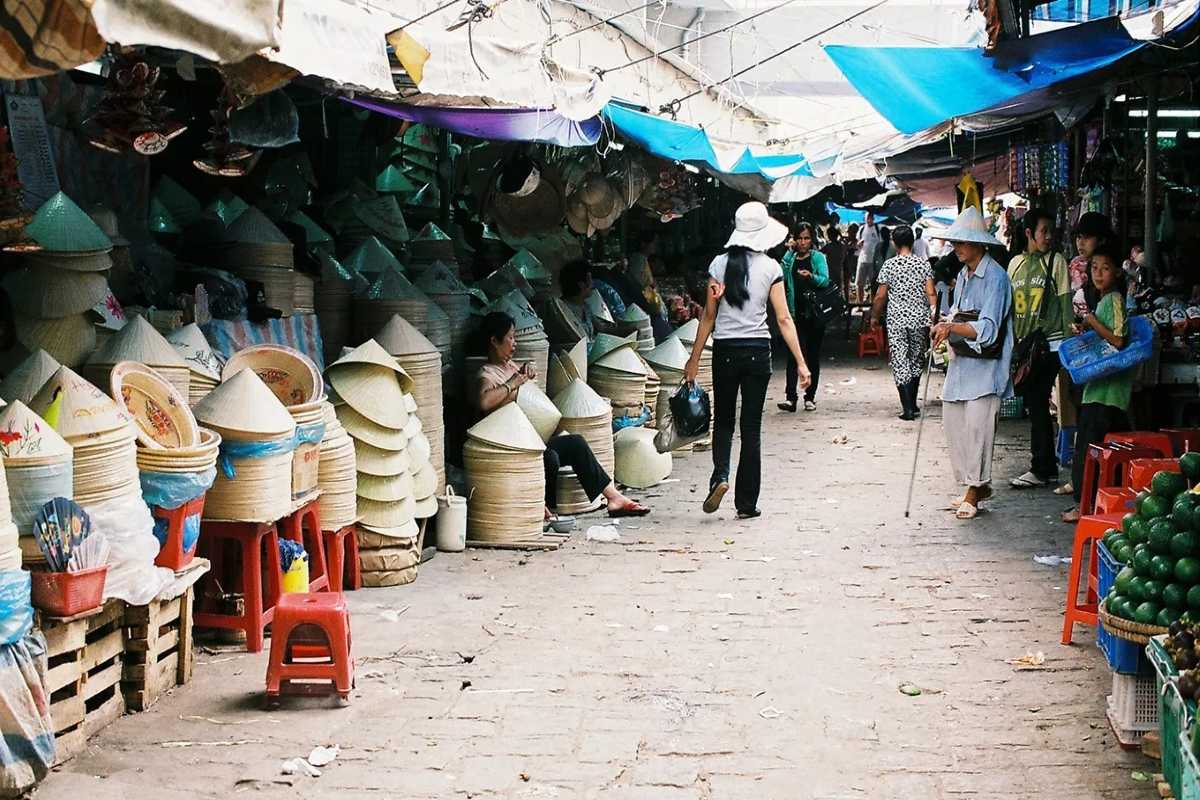 Conical Hat Alley at Dong Ba Market Hue Row of vendors selling stacks of Non Bai Tho conical hats at Dong Ba Market in Hue