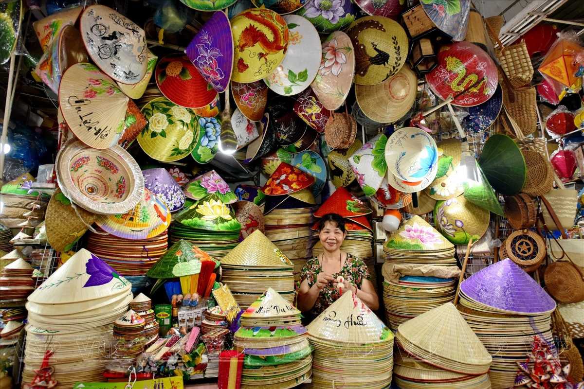 Hue Conical Hat Souvenir Stall at Dong Ba Market A conical hat vendor at Dong Ba Market displays stacks of colorful hand-painted Non Bai Tho conical hats