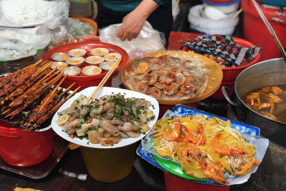 Hue Street Food Selection at Dong Ba Market Assorted traditional Hue street food including grilled skewers, banh beo, banh khoai, and shrimp pancakes