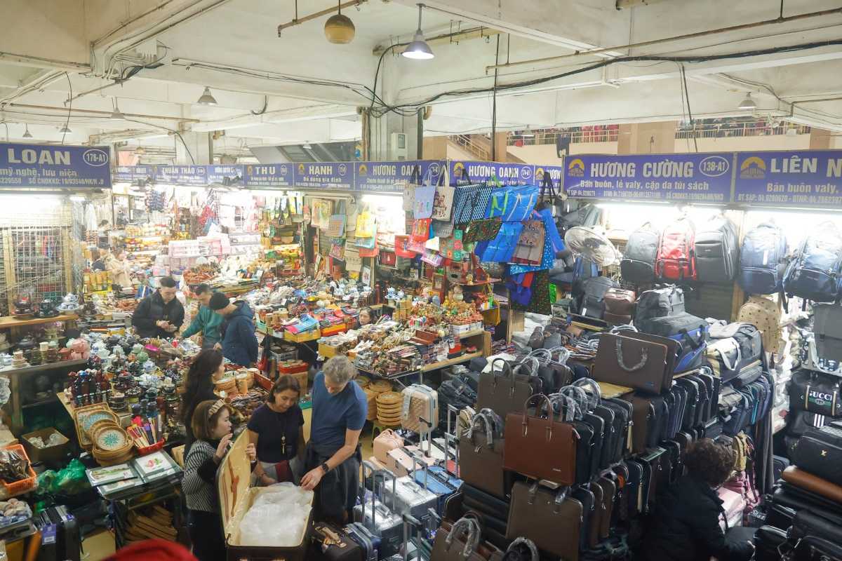 Crowded Dong Xuan Market Shopping Area Overhead view of crowded shopping floors inside Dong Xuan Market with diverse products.