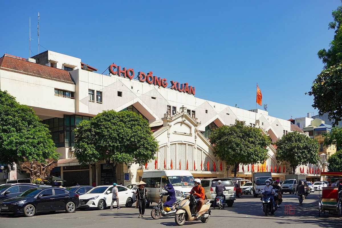 Exterior View of Dong Xuan Market Hanoi Exterior facade of the large Dong Xuan Market building in Hanoi under clear blue sky