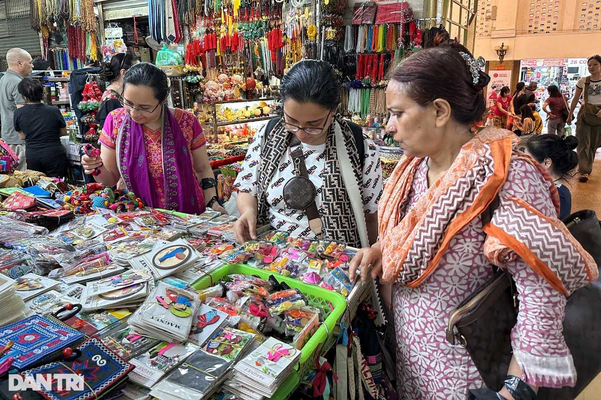 Shopping for Handicrafts at Dong Xuan Market Shoppers examining colorful handicrafts and souvenirs inside Dong Xuan Market