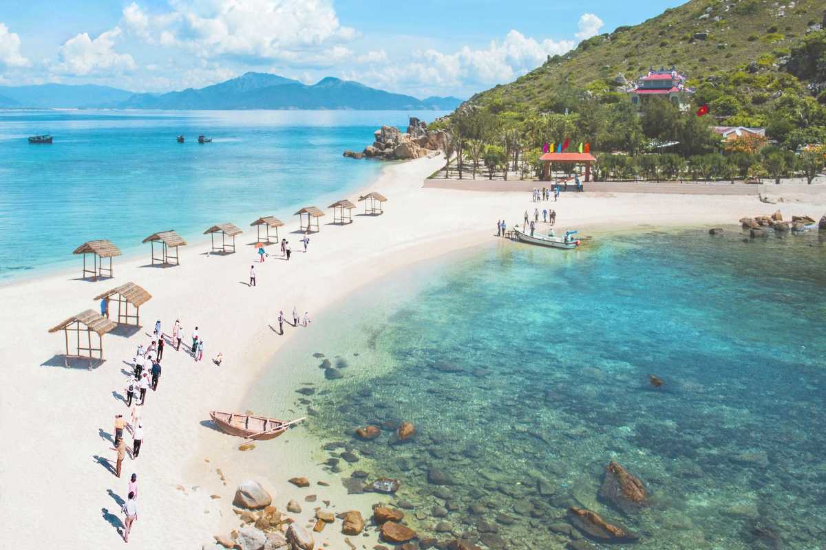 Double Beach of Yen Island White sand Double Beach at Yen Island Nha Trang with visitors walking between turquoise sea shores.