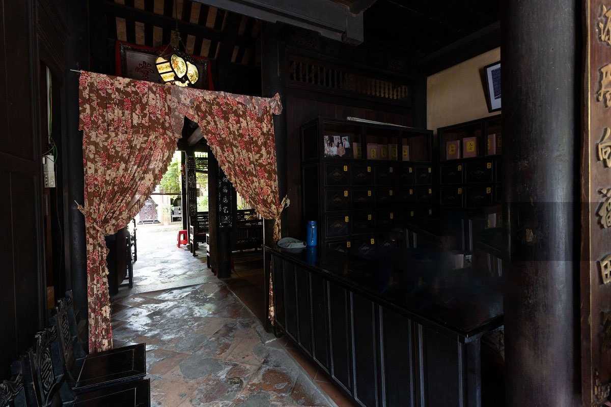 Interior with Traditional Lanterns and Paintings Interior space decorated with traditional lanterns and framed paintings at Duc An Old House.
