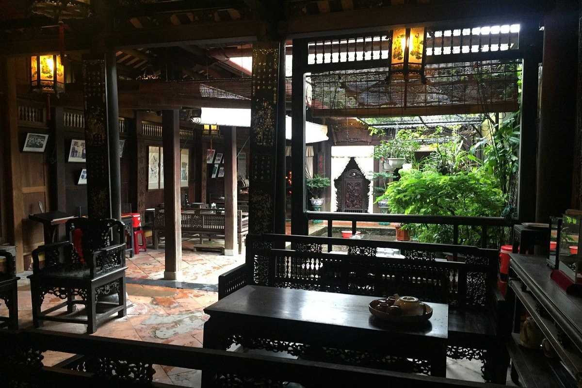 Reception Area with Wooden Desk at Duc An Old House Reception area with wooden desk and cabinets inside Duc An Old House in Hoi An.