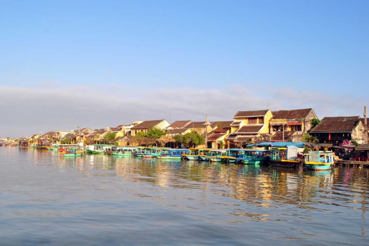 Riverside View of Historic Hoi An Near Duc An Old House Riverside scene showing boats and traditional houses near Duc An Old House in Hoi An.