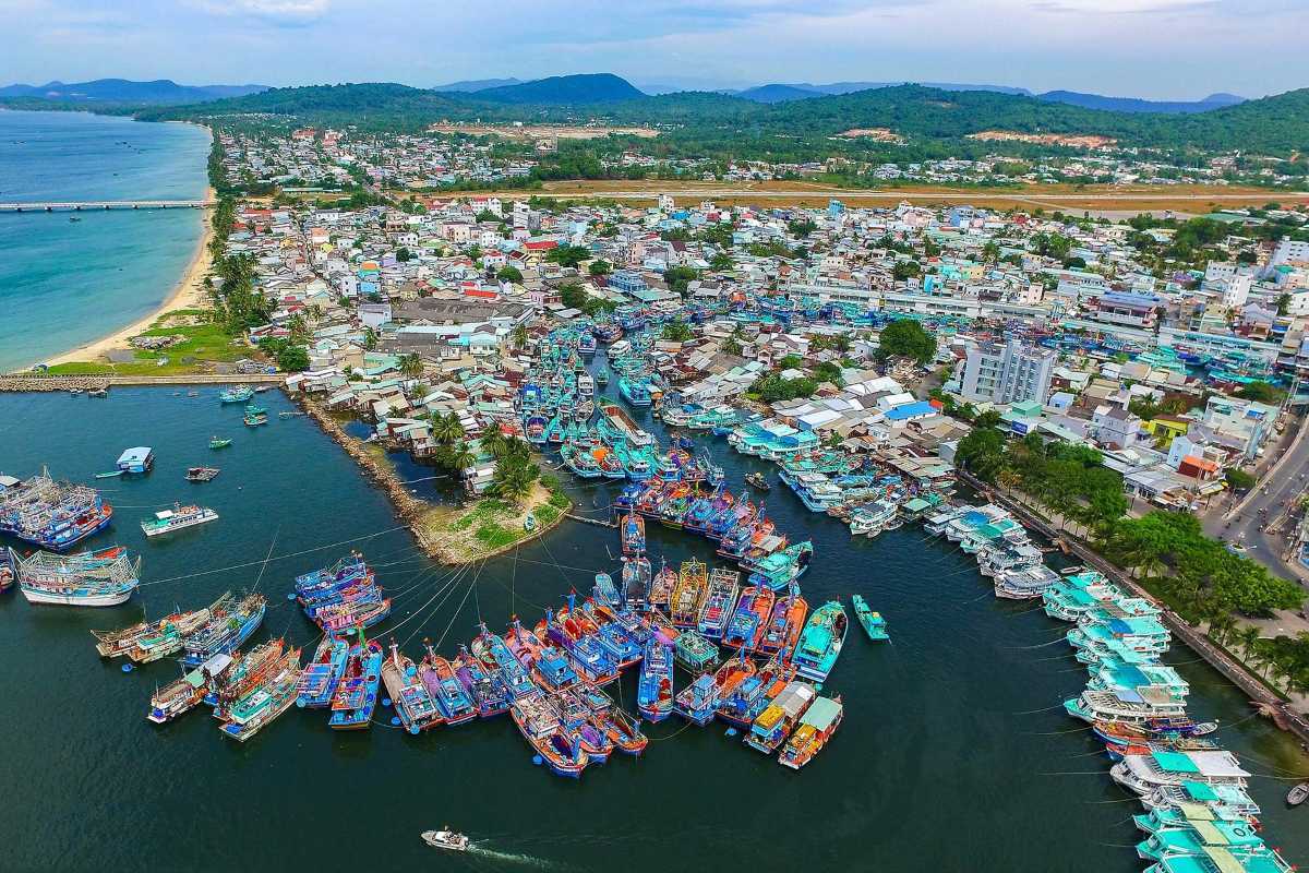 Aerial view of Duong Dong Harbor with colorful fishing boats and coastal town on Phu Quoc Island