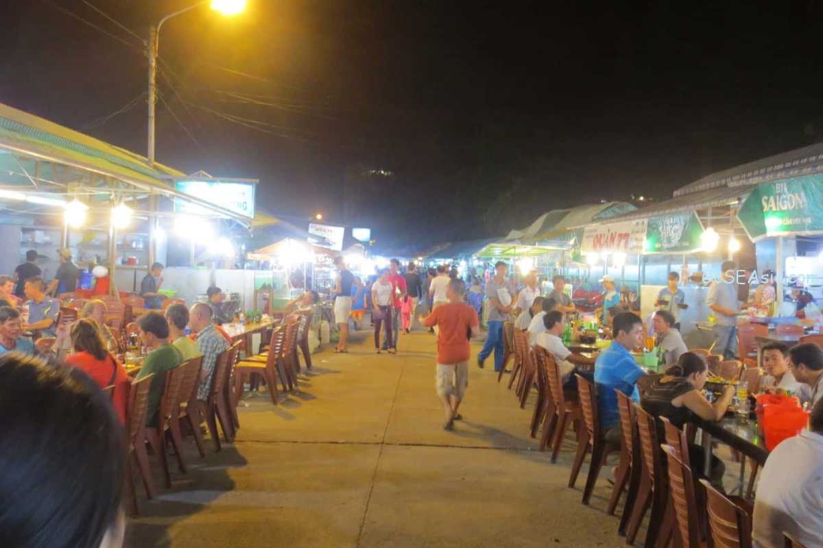 Crowded market shoppers at Duong Dong Night Market Large crowd of locals and tourists browsing goods and street food at Duong Dong Night Market Phu Quoc