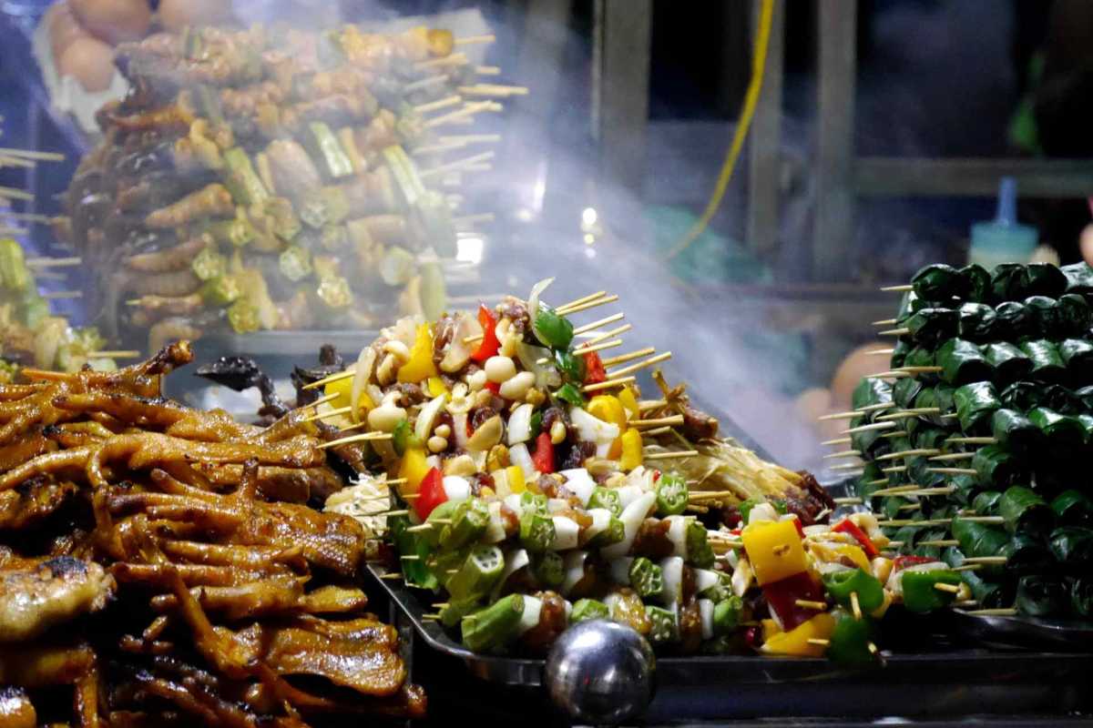 Grilled street food skewers at Duong Dong Night Market Assorted grilled skewers with meats and vegetables smoking at Duong Dong Night Market Phu Quoc