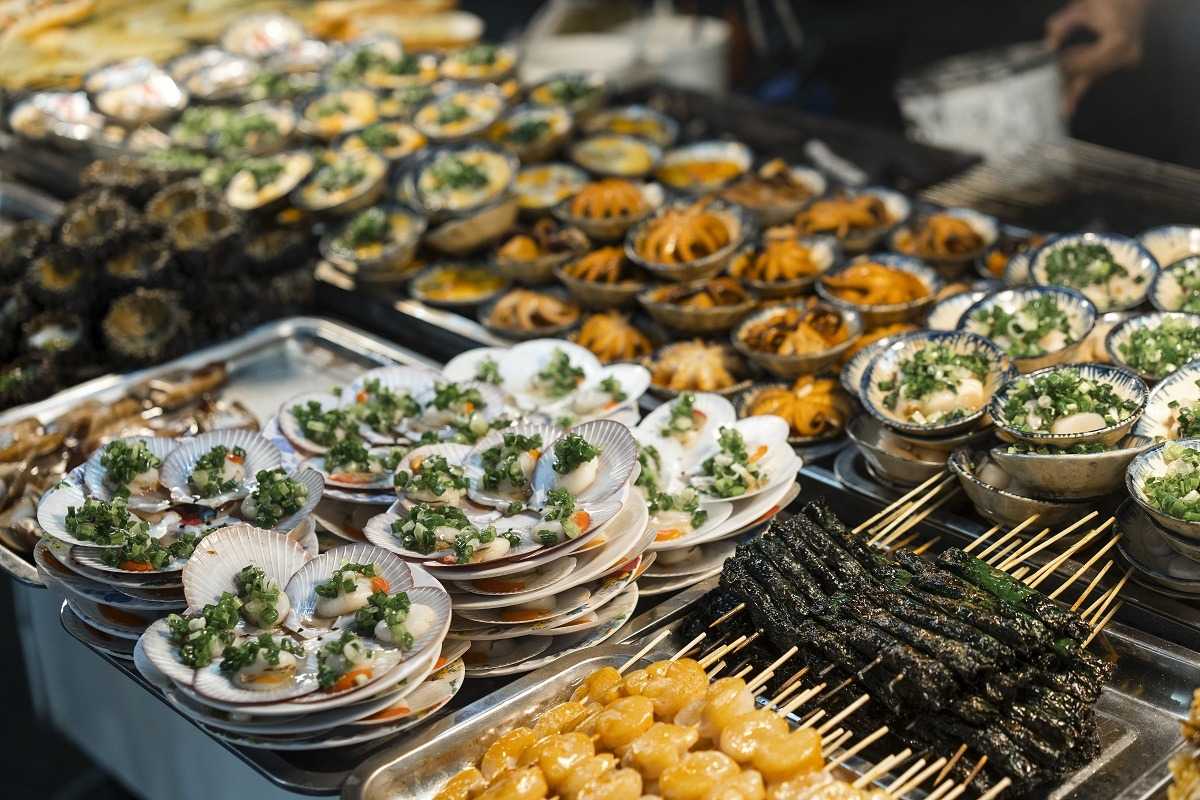 Seafood delicacies at Duong Dong Night Market Plates of fresh seafood including shellfish and grilled specialties at Duong Dong Night Market Phu Quoc
