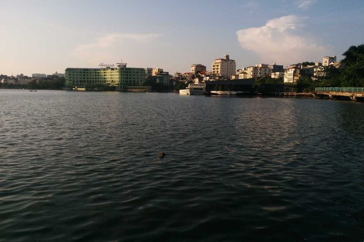 Early Morning View of West Lake Hanoi Early morning view of West Lake Hanoi with calm water and surrounding buildings