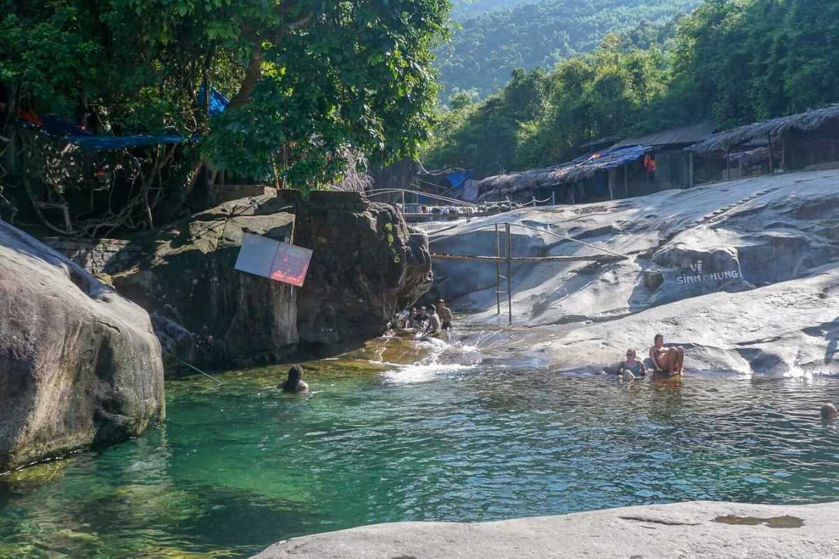 Tranquil stream and rock pools at Elephant Springs Clear natural spring water flowing through rock pools beneath shade trees at Elephant Springs in Hue
