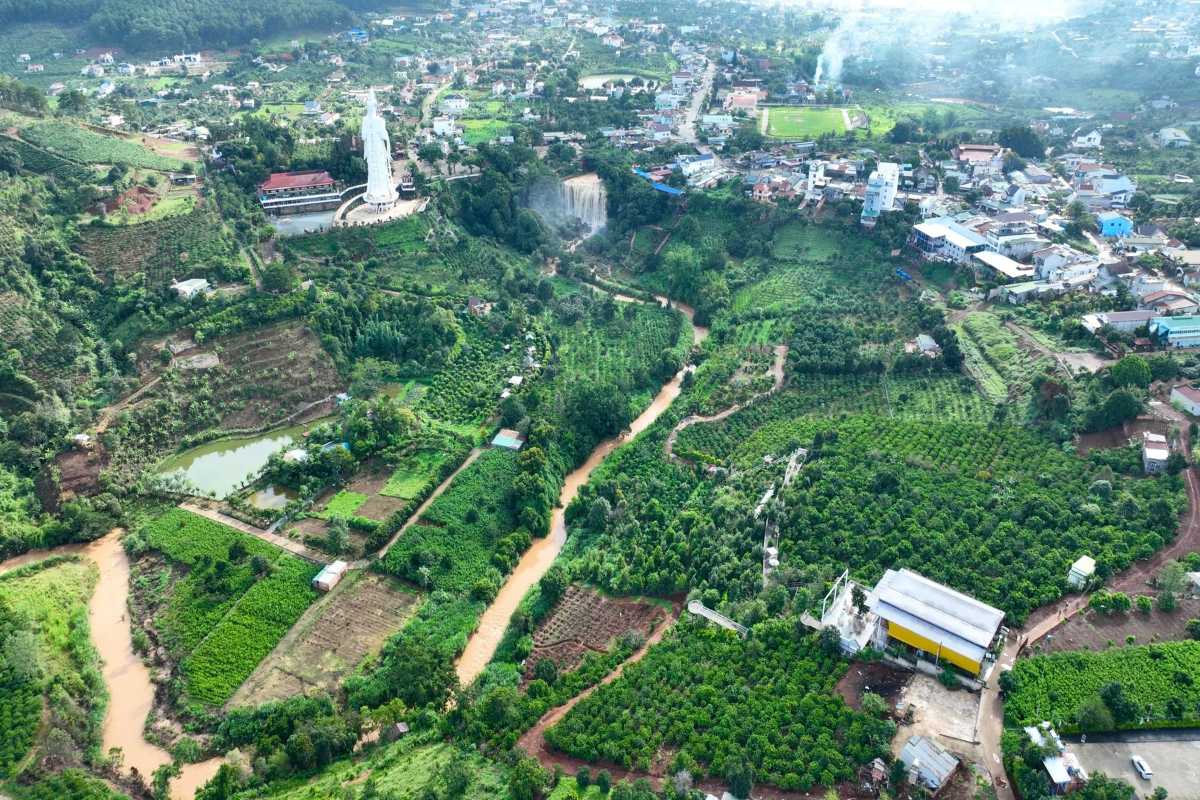 Elephant Waterfall Da Lat aerial green valley Aerial photo of Elephant Waterfall Da Lat surrounded by dense green forests and agricultural lands in the valley below