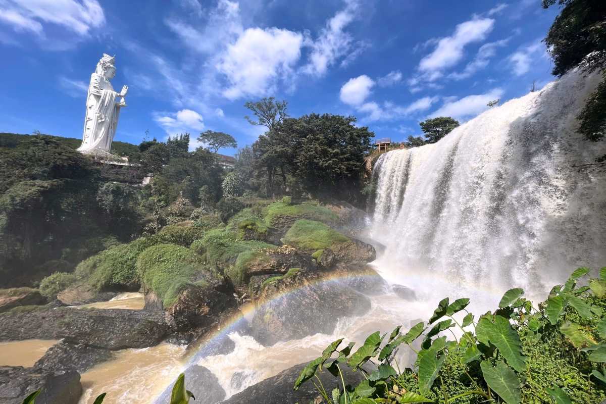 Elephant Waterfall Da Lat couple taking selfie Tourists taking a selfie on the viewing platform near Elephant Waterfall Da Lat with the falls roaring behind them