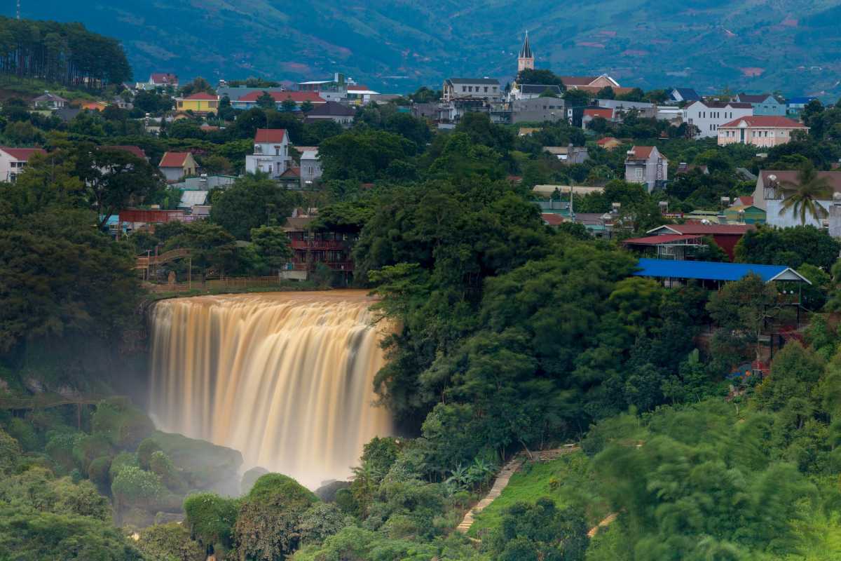 Elephant Waterfall Da Lat panoramic city view Panoramic view of Elephant Waterfall Da Lat with the cityscape and mountains in the background, showing the waterfall in front