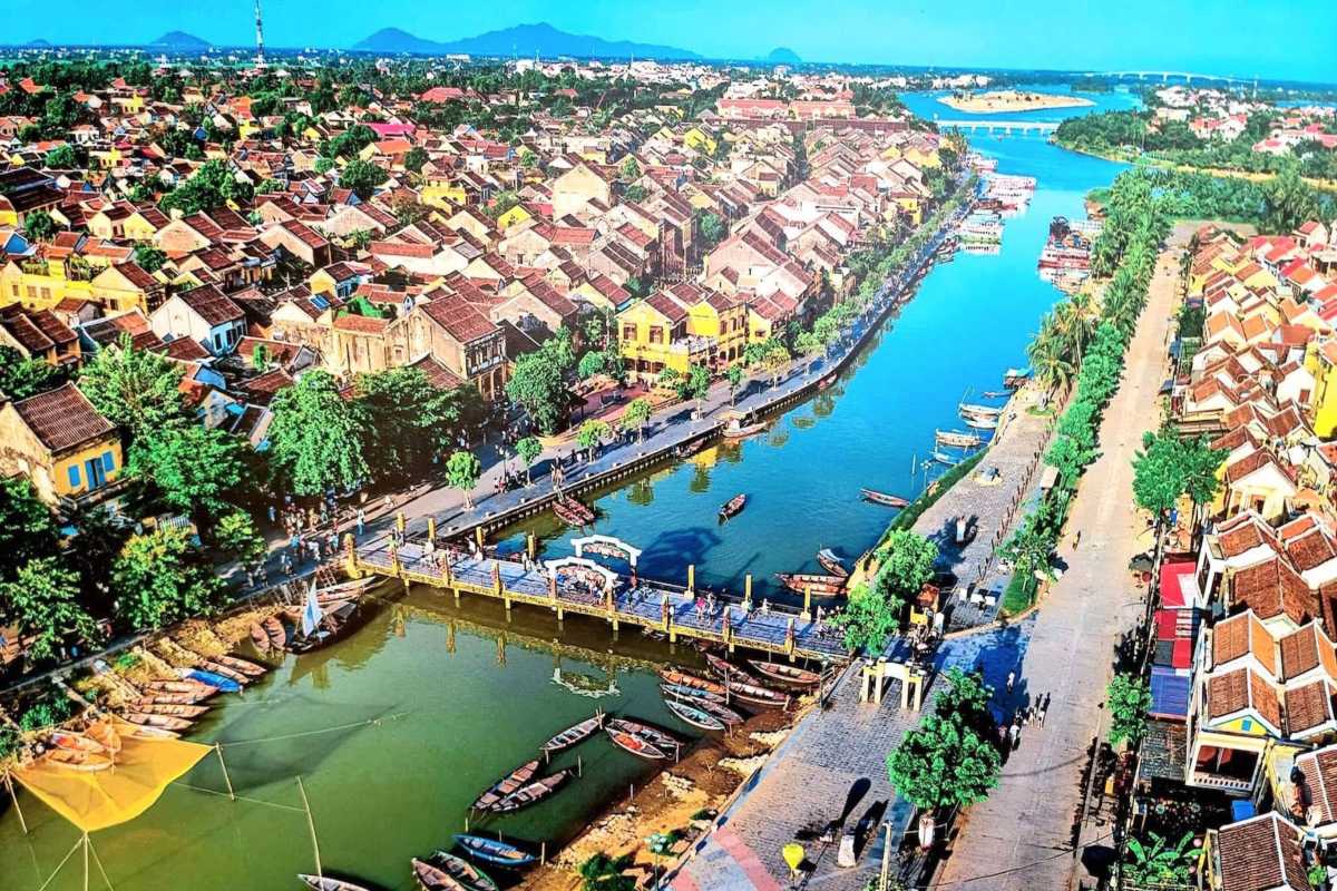 Elevated View of Japanese Bridge and Hoi An Waterfront Elevated view showing the Japanese Bridge Hoi An with boats docked nearby and townscape.
