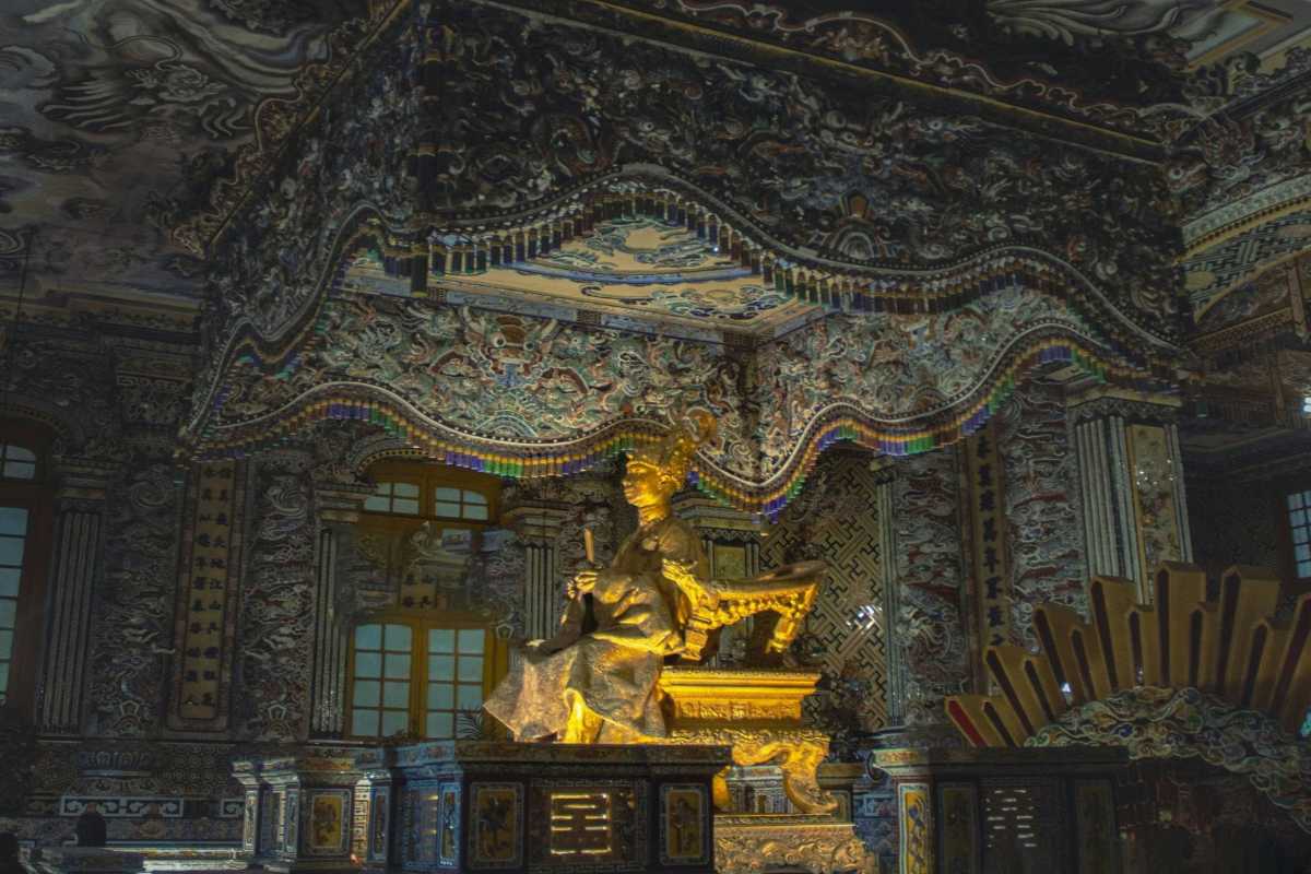 Emperor Khai Dinh’s Golden Statue Inside Main Chamber Detailed golden statue of Emperor Khai Dinh inside the elaborately decorated chamber at Khai Dinh Tomb in Hue.