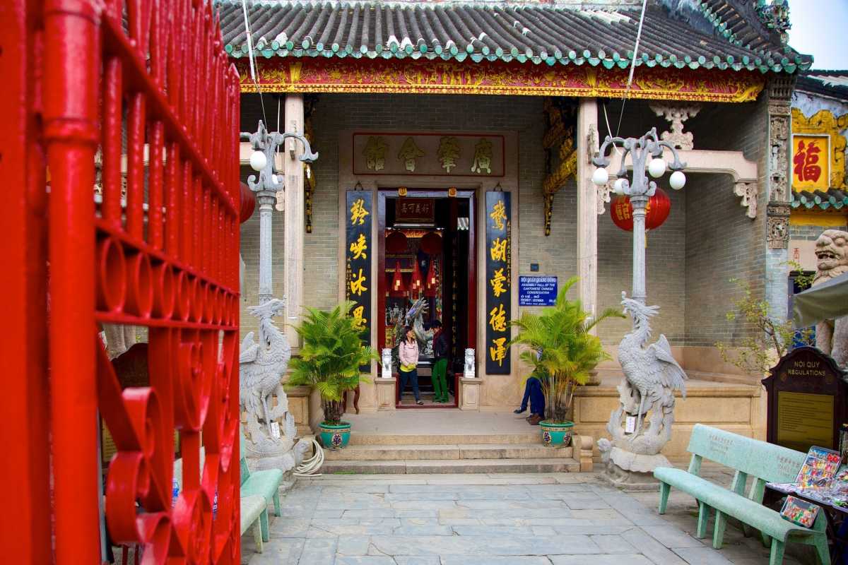 Entrance Gate of Cantonese Assembly Hall in Hoi An Entrance gate with red pillars and traditional decorations at Cantonese Assembly Hall Hoi An