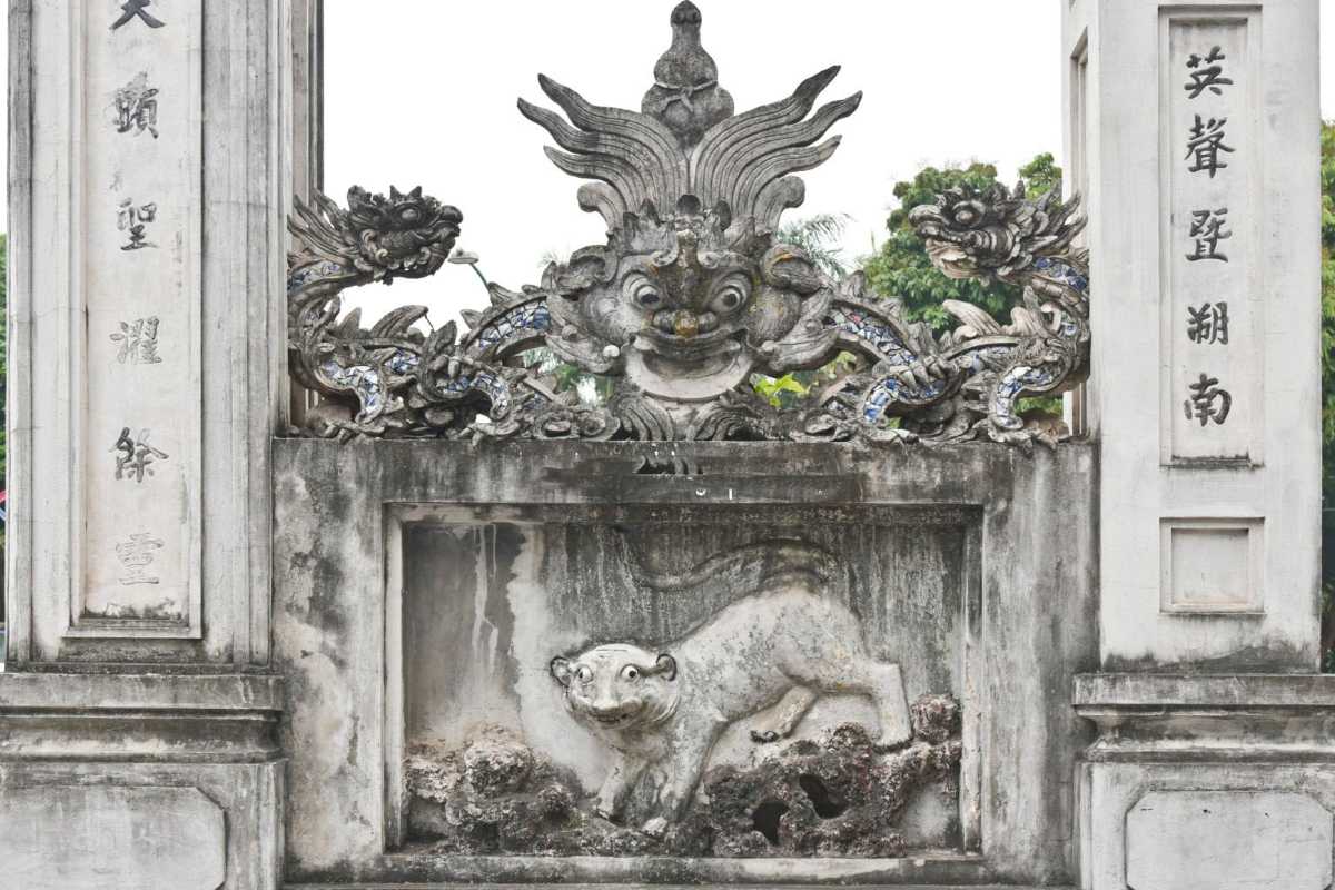 Entrance Gate Detail at Quan Thanh Temple Entrance gate with intricate stone carvings at Quan Thanh Temple in Hanoi