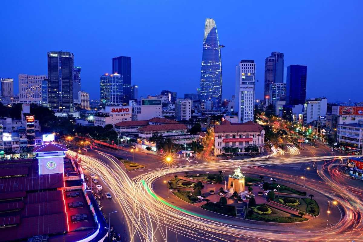 Evening Cityscape of Ho Chi Minh City with Bitexco Tower Evening cityscape featuring illuminated buildings and Bitexco Tower dominating the skyline