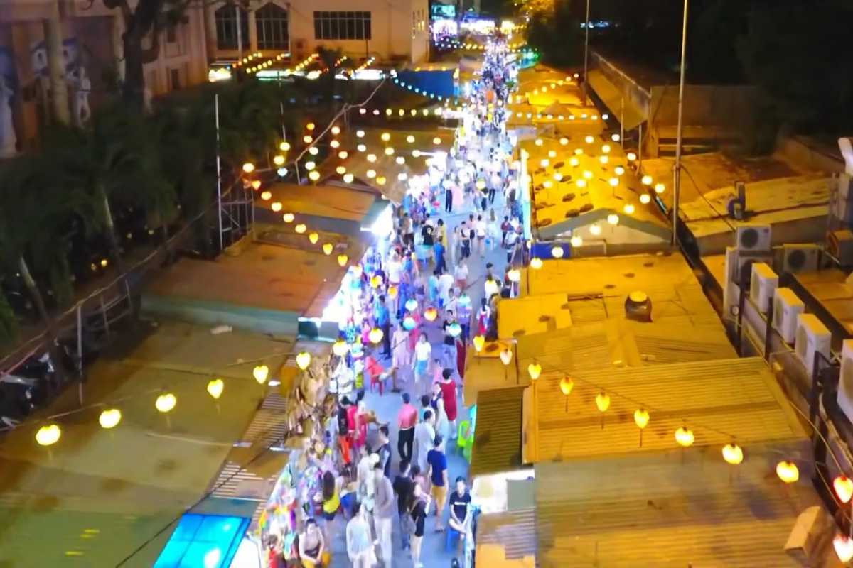 Busy Evening Shopping at Nha Trang Night Market Tourists shopping for clothes, snacks, and souvenirs at Nha Trang Night Market
