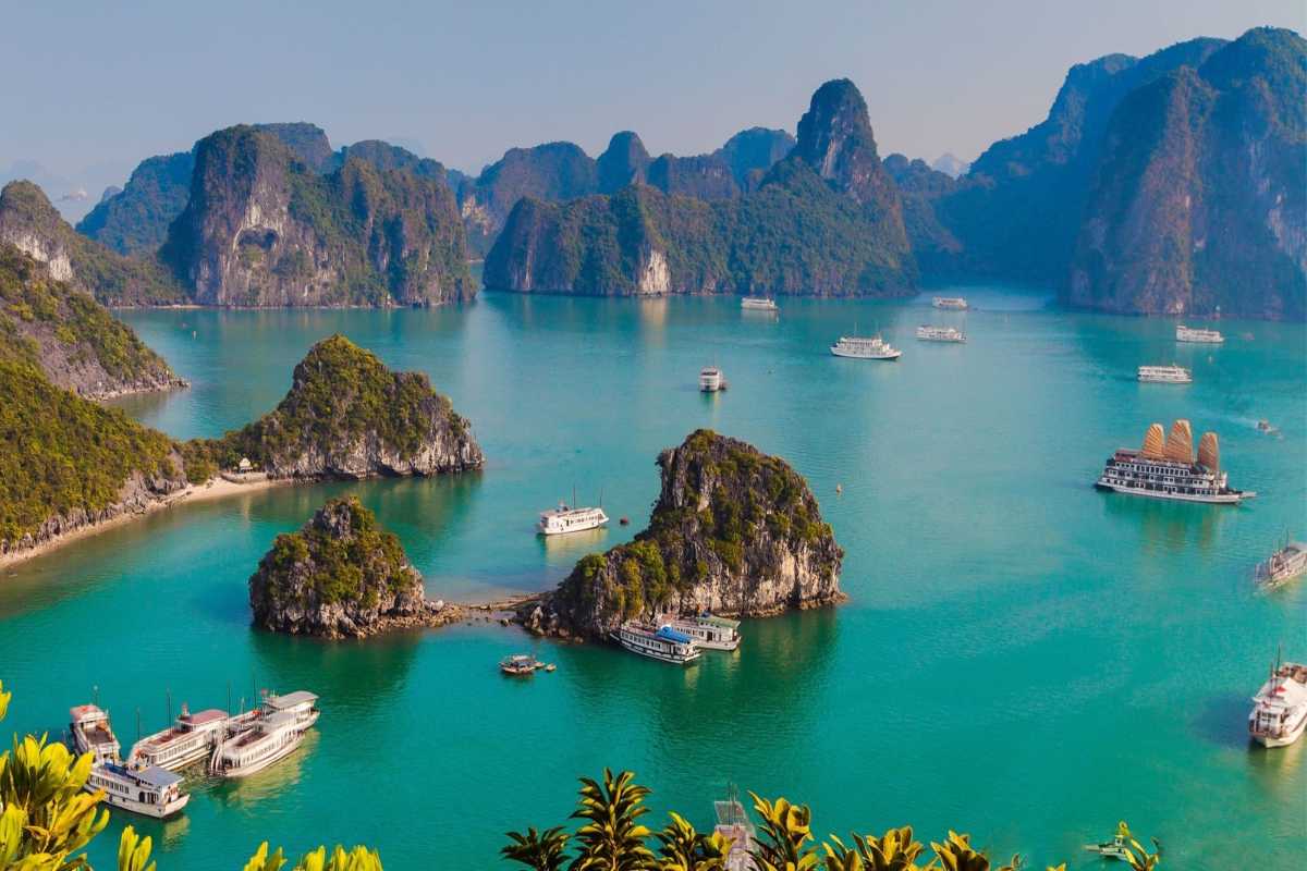 Fairy Lake Halong Bay boat cruising among karst formations Fairy Lake Halong Bay boat cruising calm waters surrounded by karst formations, offering scenic travel opportunities