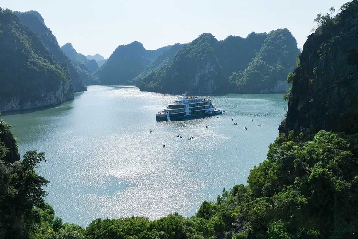 Fairy Lake Halong Bay kayak tour with limestone karsts Fairy Lake Halong Bay kayak tour navigating calm waters framed by towering limestone karsts, ideal for adventure seekers