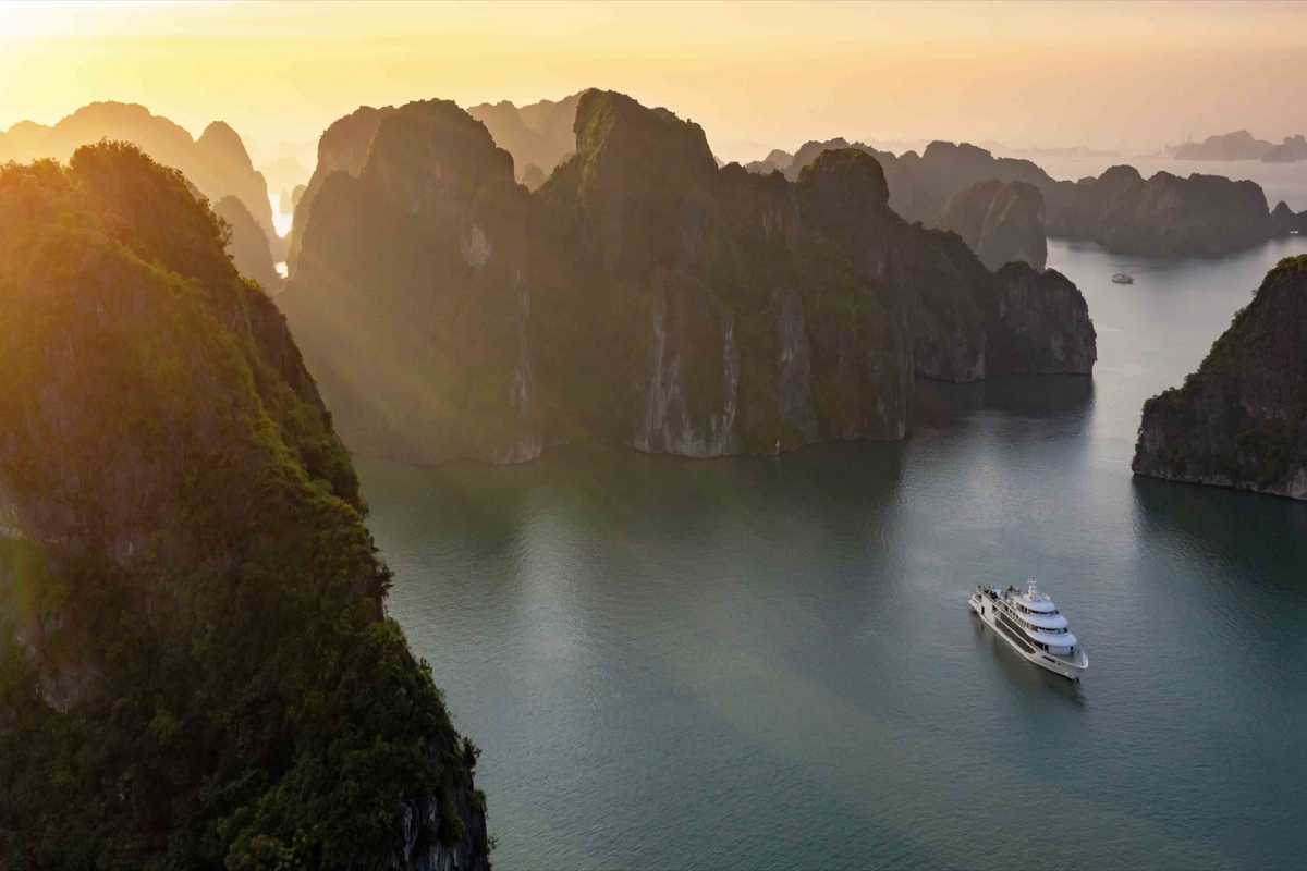 Fairy Lake Halong Bay sunset over limestone islands Fairy Lake Halong Bay sunset illuminating limestone islands with golden light, creating a magical atmosphere