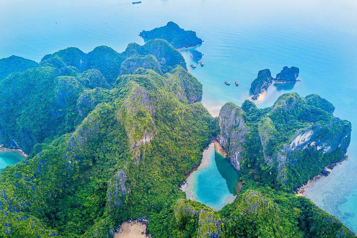 Fairy Lake Halong Bay traditional boats moored near shore Fairy Lake Halong Bay traditional wooden boats moored peacefully near the shore, reflecting local maritime culture