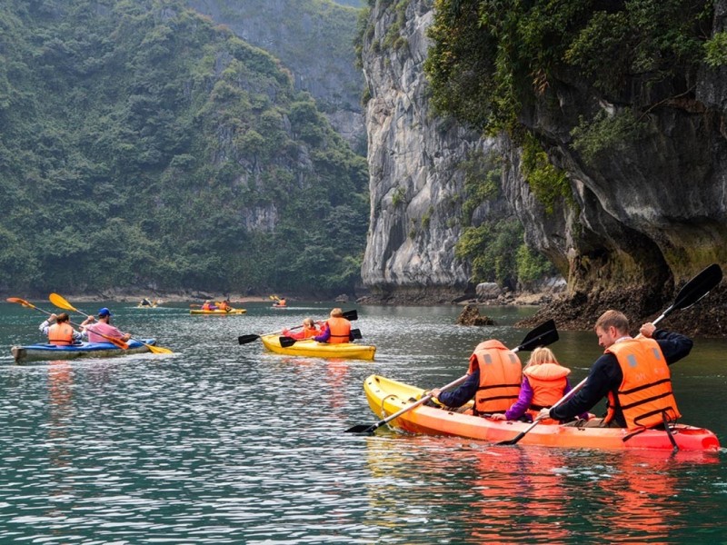 Families kayaking together in the serene waters of Lan Ha Bay