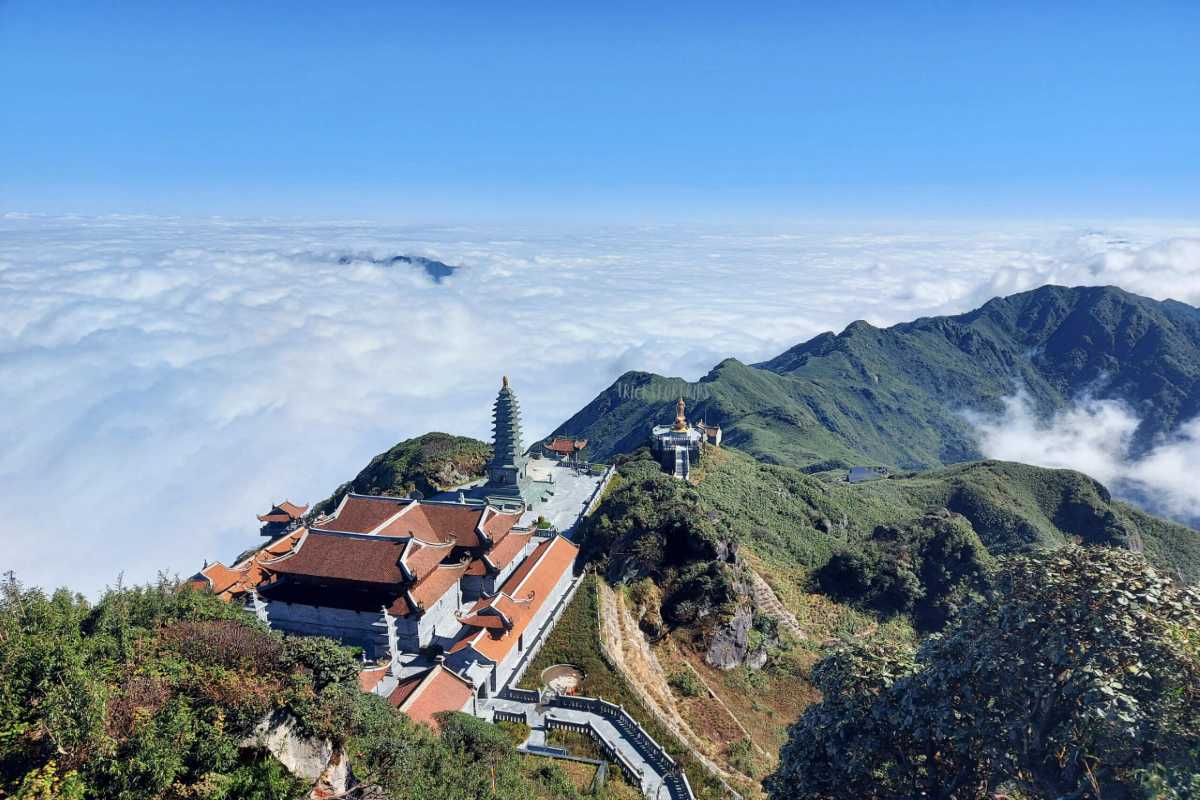 Fansipan Mountain Sapa summit pagoda above clouds Fansipan Mountain Sapa summit pagoda and temples above a vast sea of clouds with mountain ridges on a clear morning