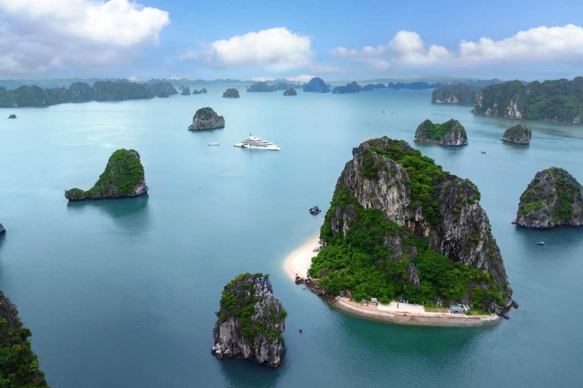 Fighting Cocks Islet Halong Bay scenic aerial island view Aerial view of Fighting Cocks Islet Halong Bay surrounded by emerald waters and nearby islands