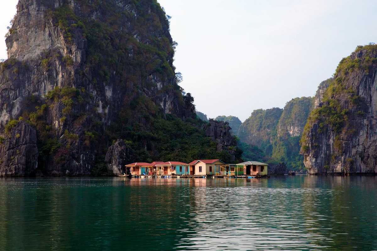 Fishing Boats Docked at Floating Village in Bai Tu Long Bay Fishing boats docked at the floating village near karst formations in Bai Tu Long Bay