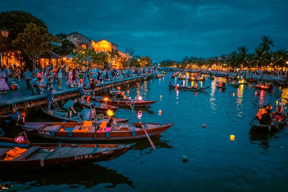 Floating Lantern Boats on Hoai River at Hoi An Night Market Wooden boats with glowing lanterns floating on the Hoai River during Hoi An Night Market