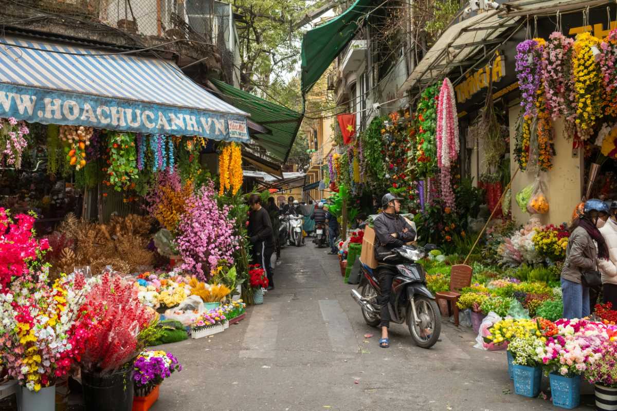 Hanoi French Quarter Flower Market Street Flower market street with colorful blooms and motorbikes in Hanoi French Quarter