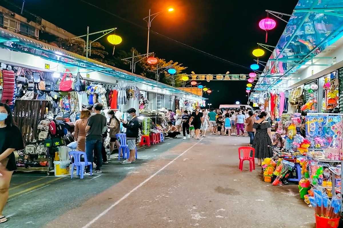 Footwear and Jewelry Stalls at Nha Trang Night Market Display of sandals, crocs, and necklaces at Nha Trang Night Market with tourists browsing
