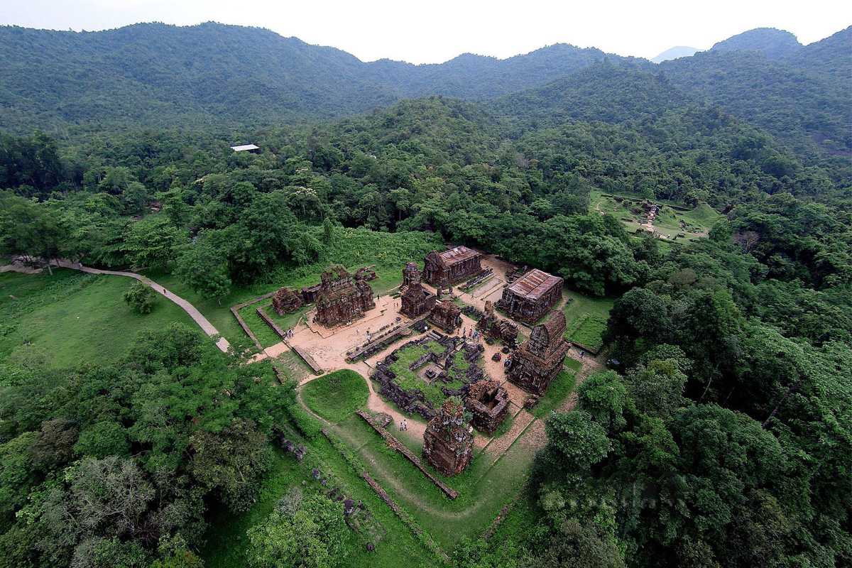 Forest Surrounding My Son Sanctuary Temples Lush green forest enveloping the ancient ruins of My Son Sanctuary, highlighting the natural environment around the heritage site