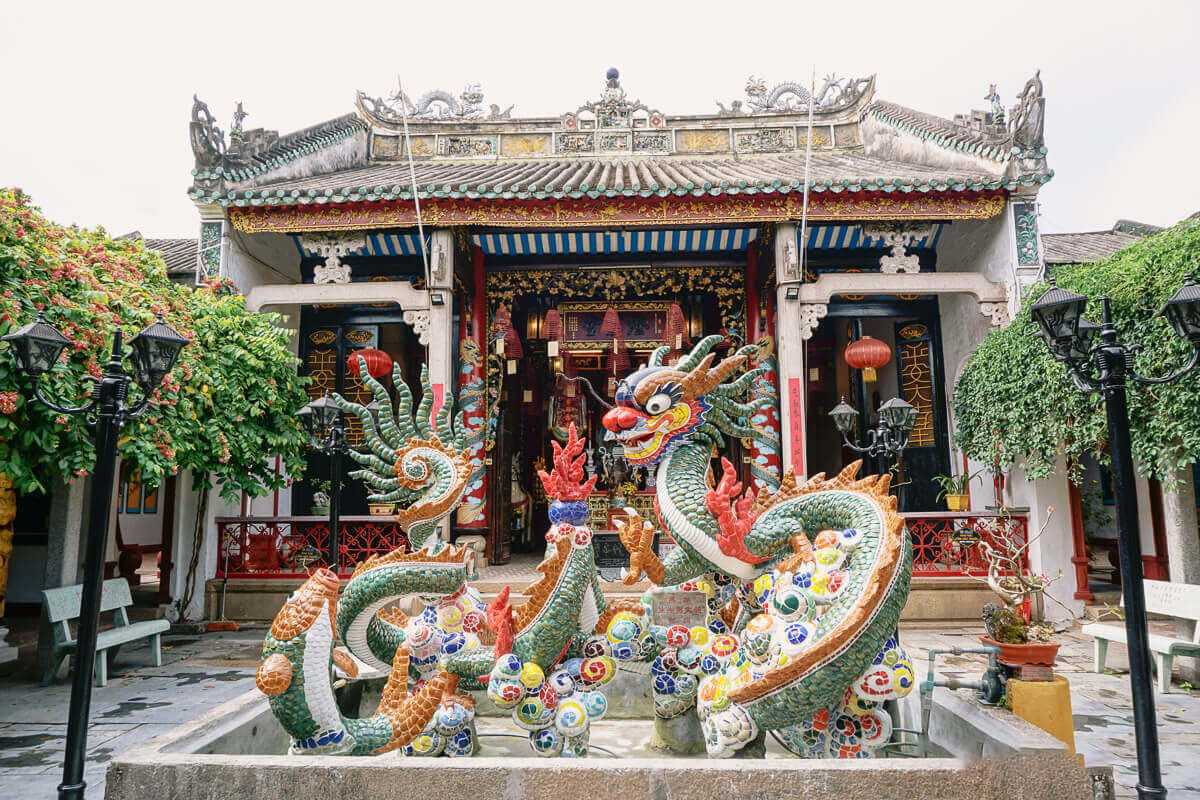 Front View of Cantonese Assembly Hall with Red Gate Front facade with red gate and ornamental pillars at Cantonese Assembly Hall Hoi An