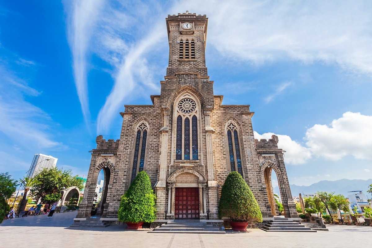 Front View of Stone Church Nha Trang Cathedral Front facade of Stone Church Nha Trang Cathedral with large entrance and manicured bushes