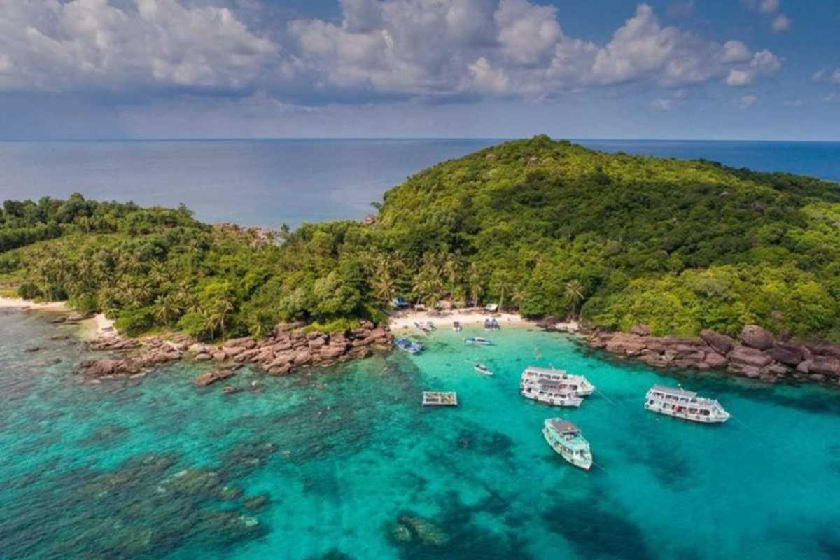 Gam Ghi Island Phu Quoc aerial view with boats and coral reefs Aerial shot of boats near coral reefs and clear waters around Gam Ghi Island Phu Quoc