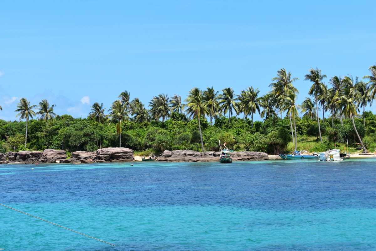 Boats anchored near Gam Ghi Island Phu Quoc coral reefs Several boats anchored in clear water over coral reefs near Gam Ghi Island Phu Quoc