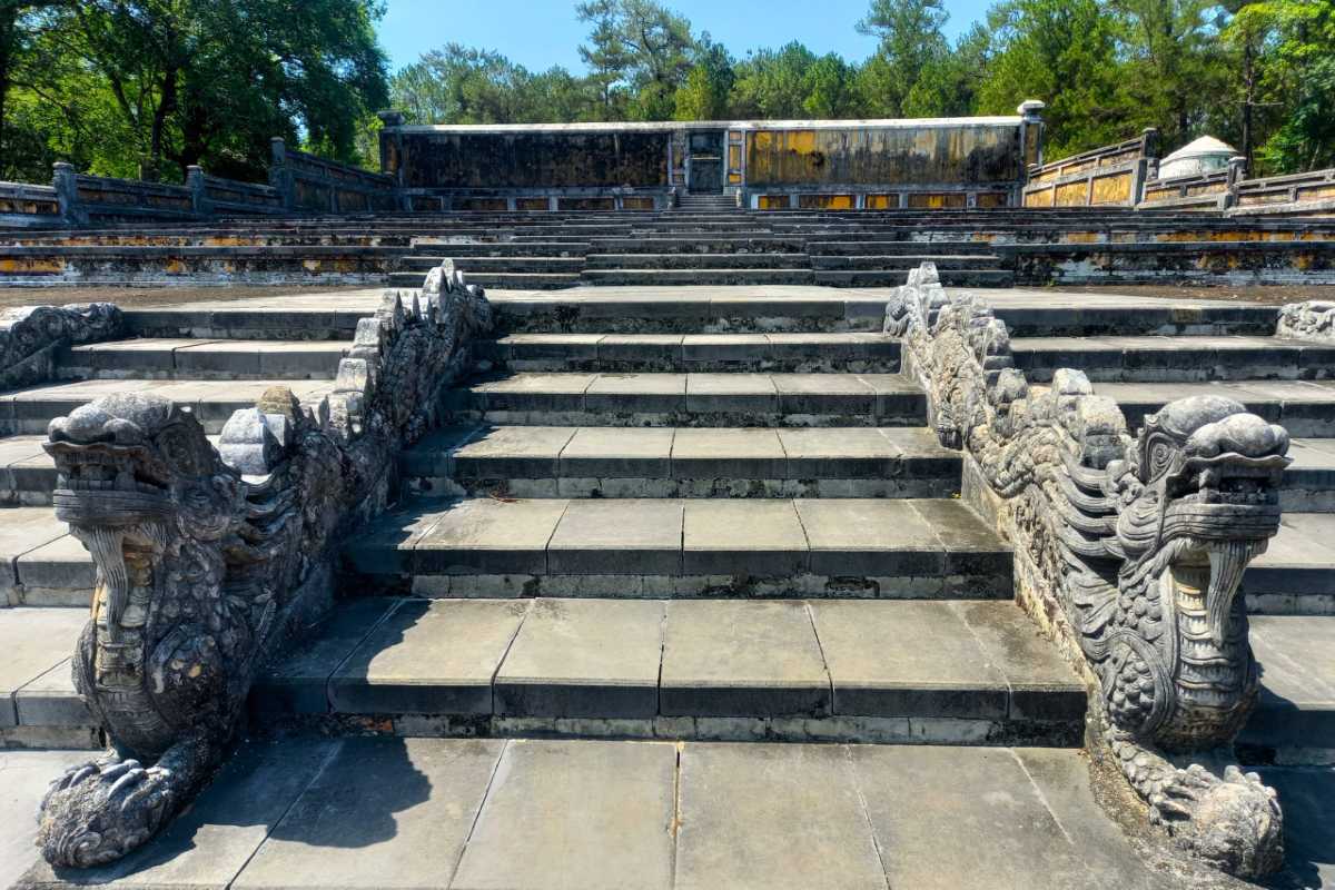 Dragon-Carved Staircase at Gia Long Tomb Hue Close-up of dragon-carved stone staircase at Gia Long Tomb, showing detailed dragon motifs in Hue, Vietnam.