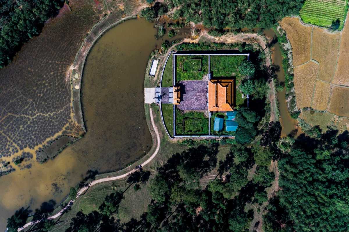 Aerial View of Lakeside Pavilion at Gia Long Tomb Aerial shot of a lakeside pavilion and walled enclosure, bordered by pine trees and waterways at Gia Long Tomb, Hue.